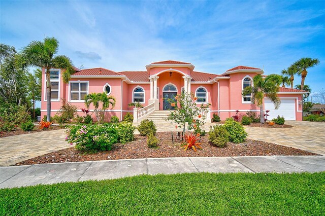 mediterranean / spanish house with a garage