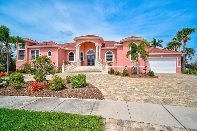 mediterranean / spanish-style house with a garage