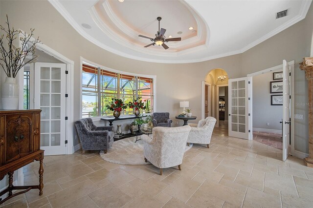 living room featuring light tile flooring, a tray ceiling, ceiling fan, and french doors