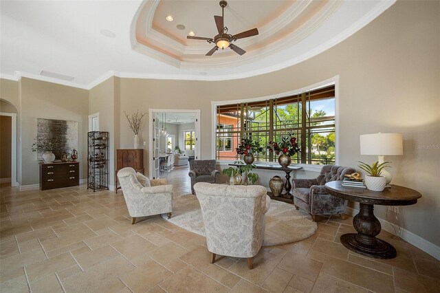 living room with ceiling fan, light tile floors, and a wealth of natural light