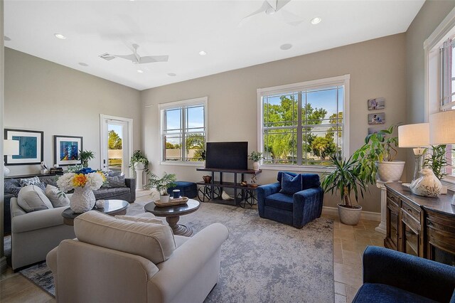 tiled living room with ceiling fan