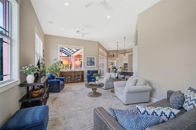 carpeted living room with ceiling fan