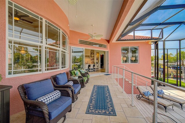 sunroom with plenty of natural light and ceiling fan