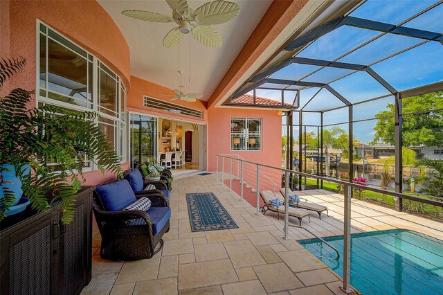 sunroom featuring vaulted ceiling and ceiling fan