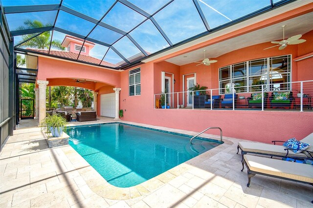 view of swimming pool featuring a patio, an outdoor living space, ceiling fan, and glass enclosure