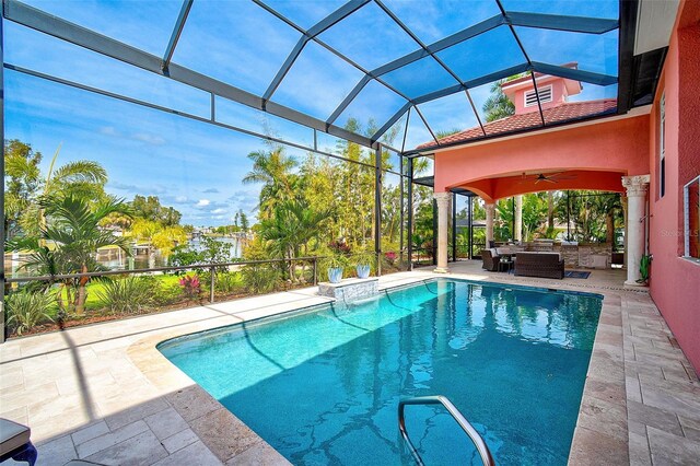 view of swimming pool with an outdoor hangout area, a patio, ceiling fan, and glass enclosure