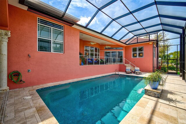 view of swimming pool with a patio and glass enclosure