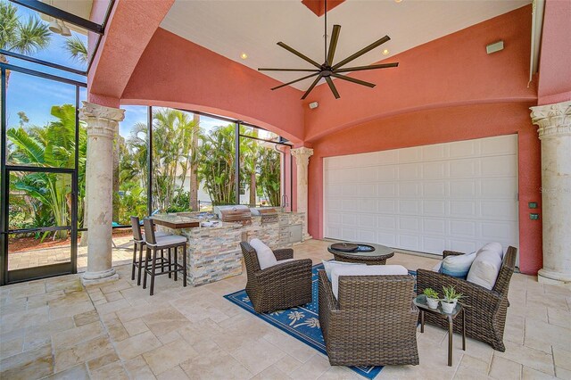 view of patio / terrace with grilling area, ceiling fan, a bar, a lanai, and area for grilling