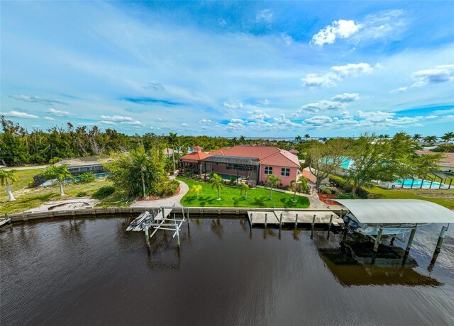 view of dock featuring a lawn and a water view