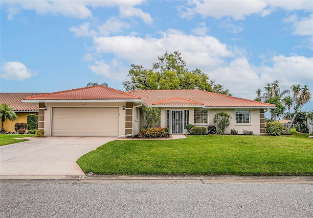 view of front of property featuring a garage and a front yard