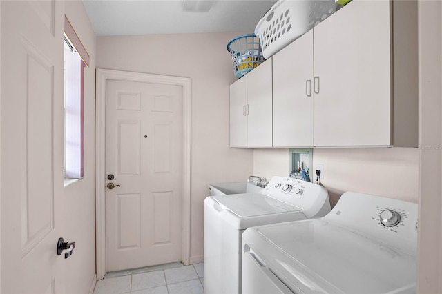 washroom with cabinets, sink, light tile patterned floors, and independent washer and dryer