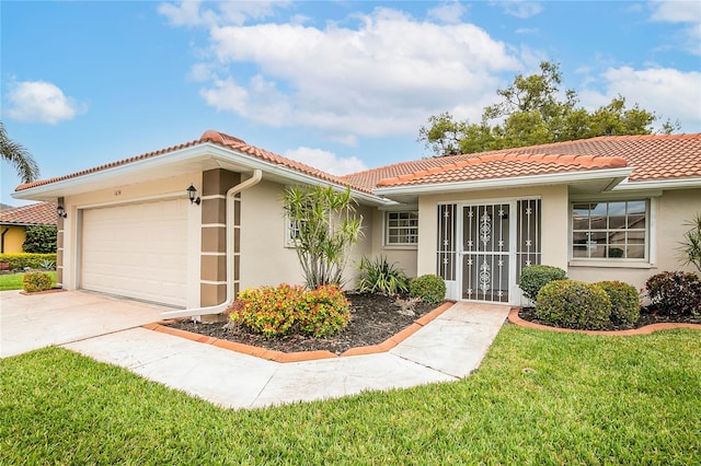 view of front of house featuring an attached garage, a tile roof, concrete driveway, and stucco siding