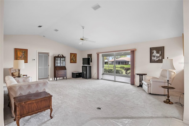 living area featuring lofted ceiling, ceiling fan, visible vents, and light colored carpet