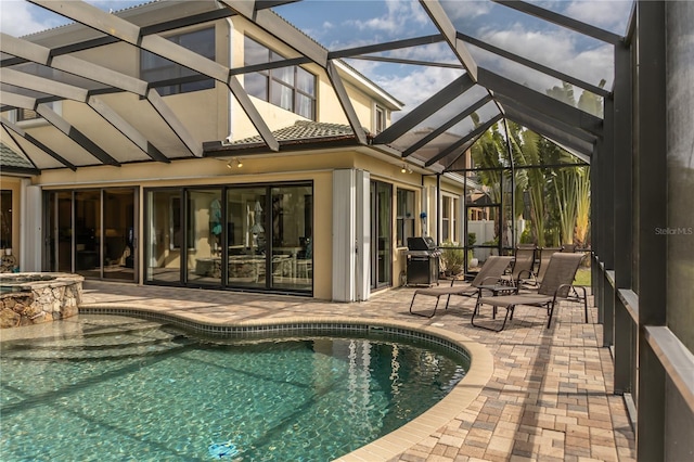 view of pool with a lanai and a patio