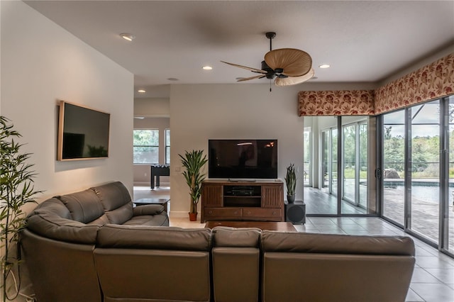 living room featuring ceiling fan and light tile patterned floors