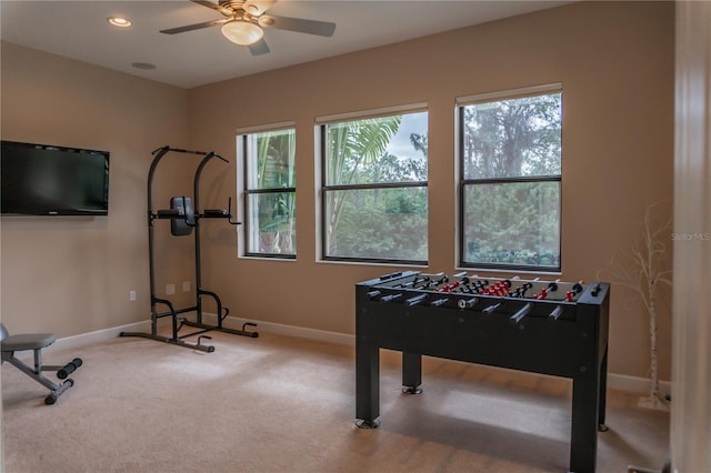 interior space with carpet flooring and ceiling fan