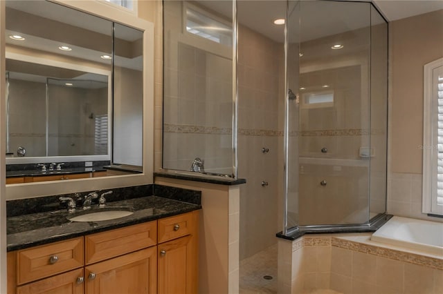 bathroom with independent shower and bath and vanity