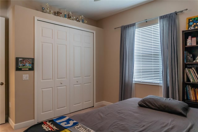 carpeted bedroom with a closet