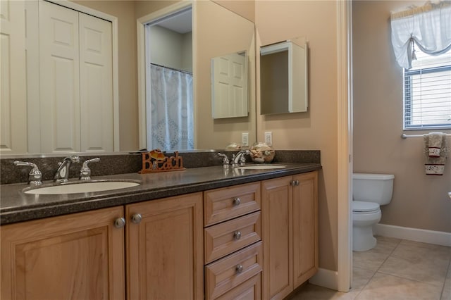 bathroom featuring tile patterned floors, toilet, and vanity