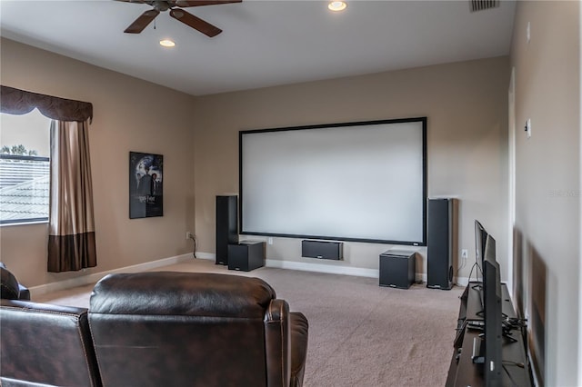 cinema room with ceiling fan and carpet flooring