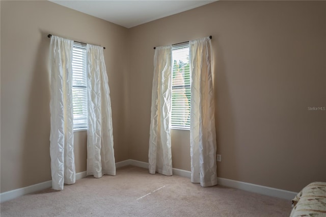 empty room with light colored carpet