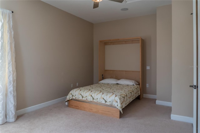 bedroom with ceiling fan and light carpet