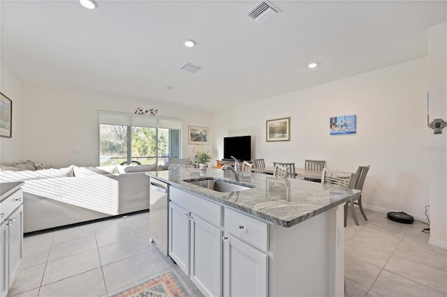 kitchen featuring white cabinetry, light tile flooring, and sink