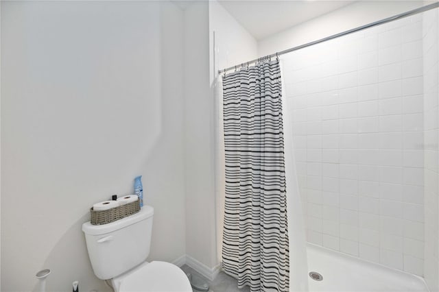 bathroom featuring toilet and walk in shower