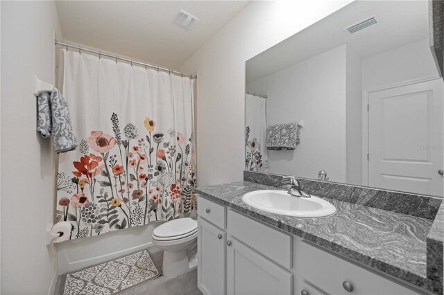 full bathroom with toilet, large vanity, shower / bath combo, and tile flooring