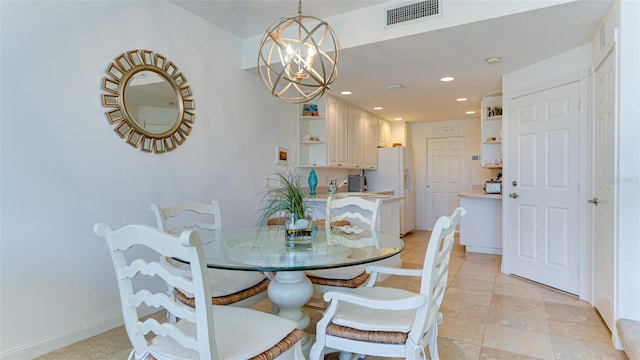 tiled dining space with an inviting chandelier