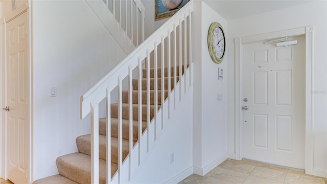 stairs with light tile flooring