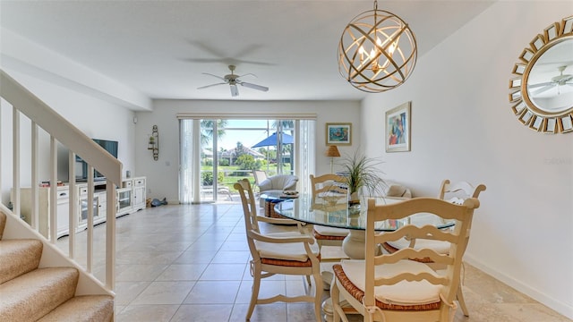 tiled dining space featuring ceiling fan with notable chandelier