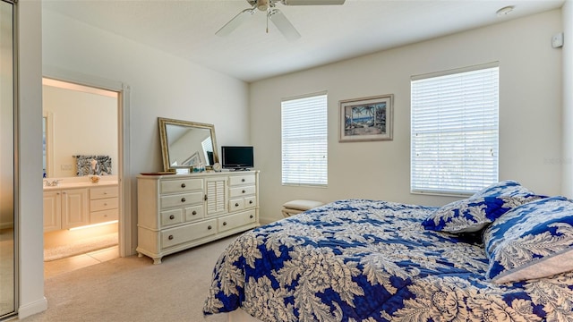 carpeted bedroom with connected bathroom and ceiling fan