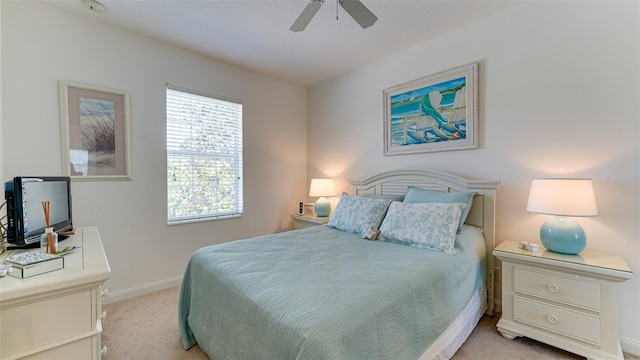 bedroom with light carpet and ceiling fan