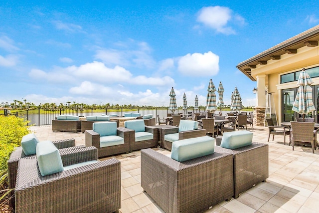 view of patio with a water view and an outdoor hangout area