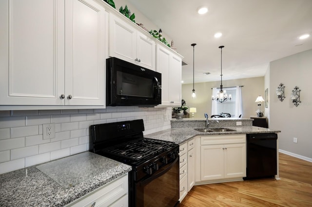 kitchen featuring sink, white cabinetry, and black appliances