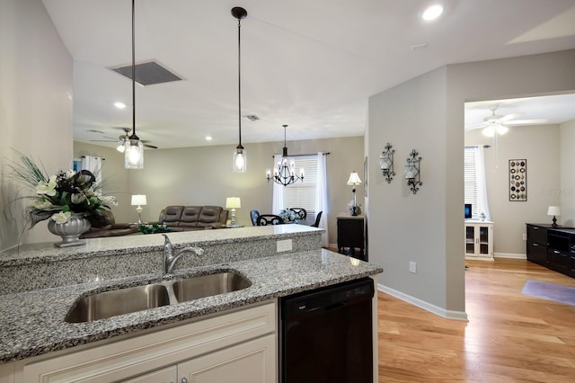 kitchen with white cabinetry, light stone countertops, sink, black dishwasher, and light hardwood / wood-style floors