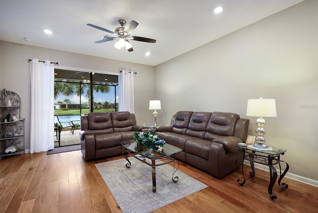 living room featuring ceiling fan and hardwood / wood-style flooring