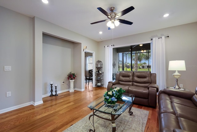 living room with hardwood / wood-style floors and ceiling fan