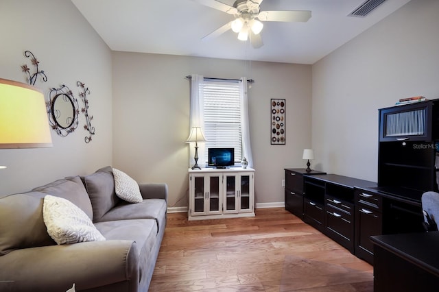 living room featuring ceiling fan and light hardwood / wood-style floors