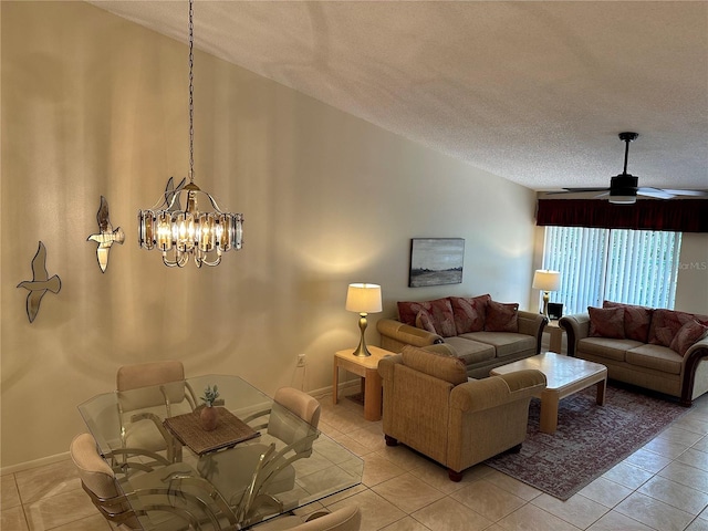 tiled living room with a textured ceiling and ceiling fan with notable chandelier