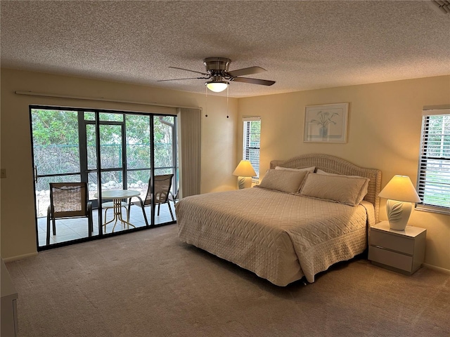 bedroom featuring access to exterior, carpet flooring, ceiling fan, and a textured ceiling