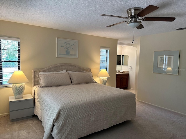 carpeted bedroom featuring connected bathroom, a textured ceiling, and ceiling fan