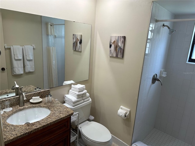 bathroom with toilet, vanity, and a shower with curtain