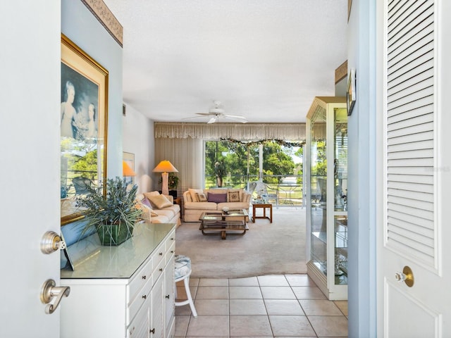 carpeted living room featuring ceiling fan