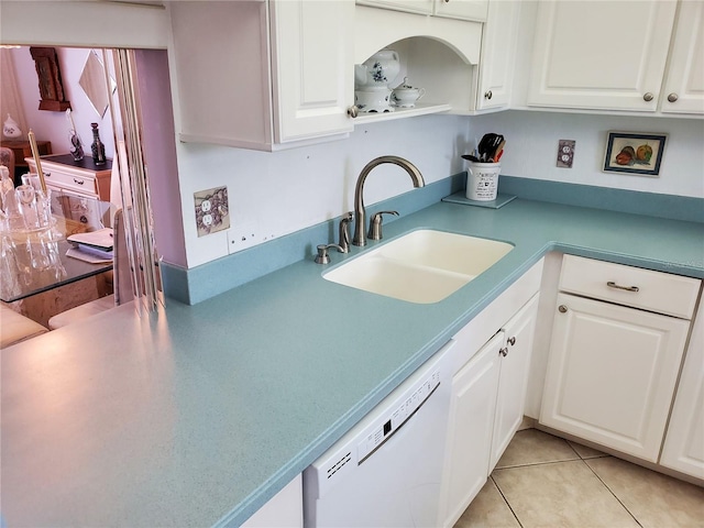 kitchen featuring white cabinetry, sink, white dishwasher, and light tile patterned floors