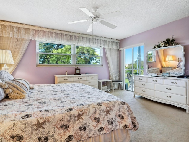 bedroom featuring ceiling fan, light colored carpet, and a textured ceiling