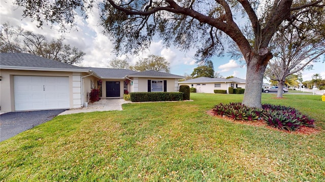 ranch-style house featuring a garage and a front yard