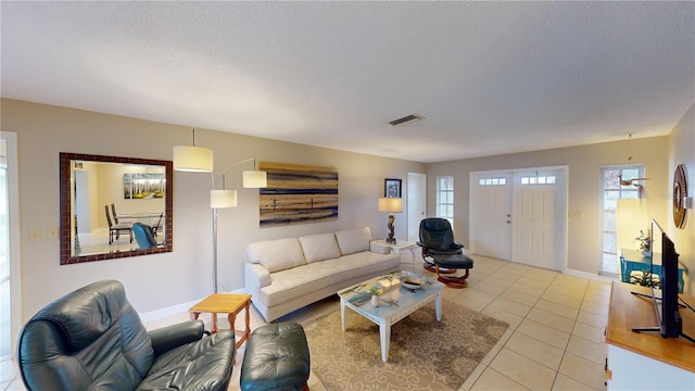 tiled living room with a textured ceiling