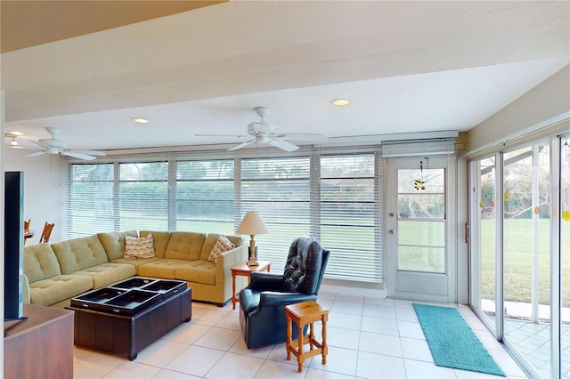 sunroom / solarium featuring ceiling fan